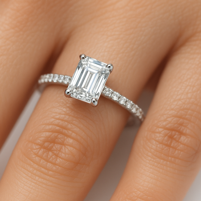 featuring A emerald cut lab grown diamond  rings with 1 carat  as main stone, smaller round diamond at its pave.  This ring is putting on a female model's finger,holding 4 prongs setting, made with 14k white gold.